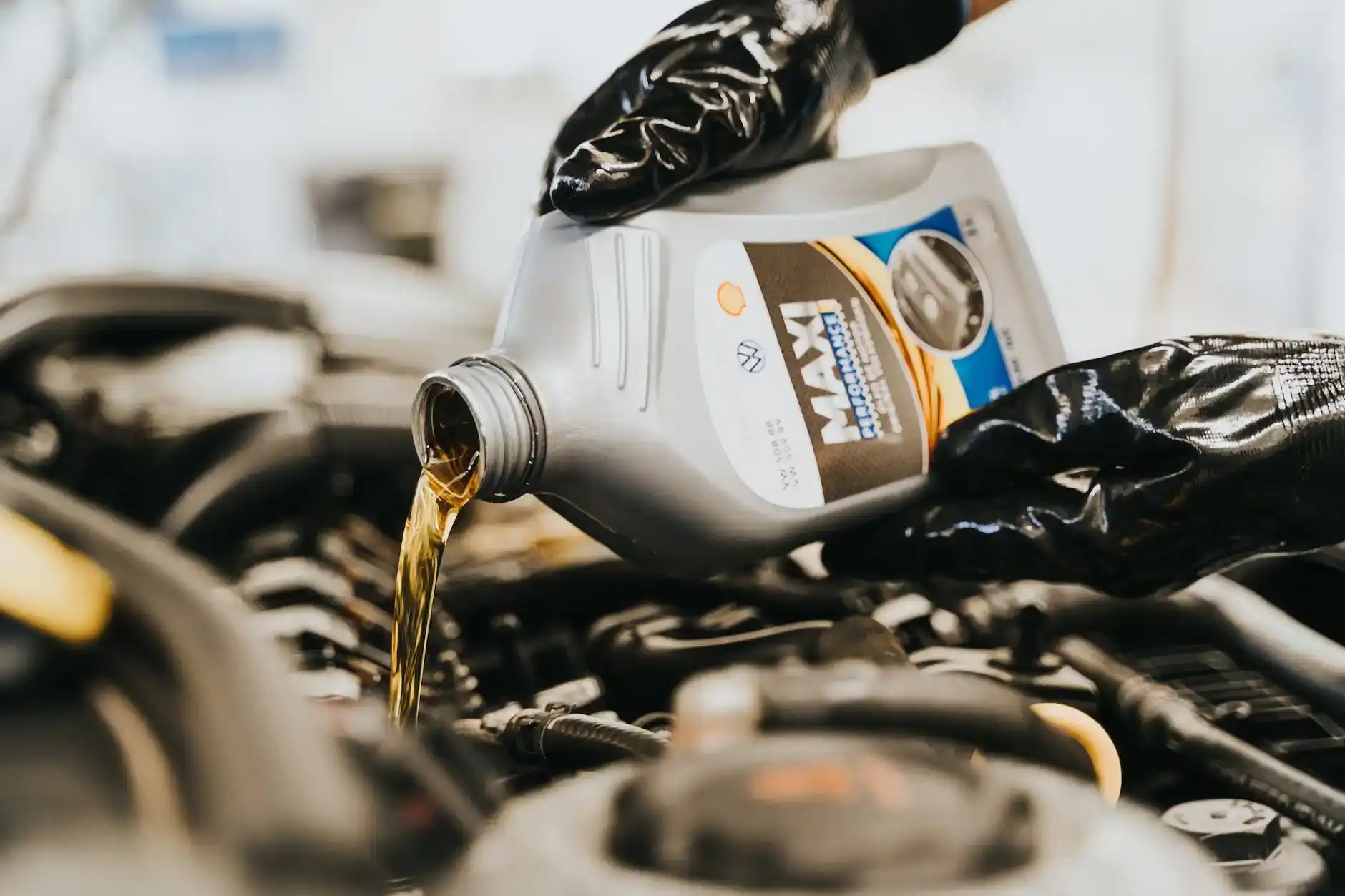 close up of pouring oil to engine